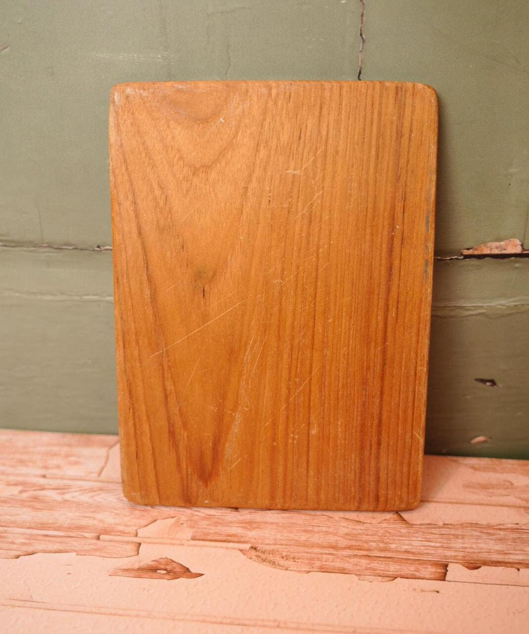 A vintage wooden chopping board for use in the kitchen.
