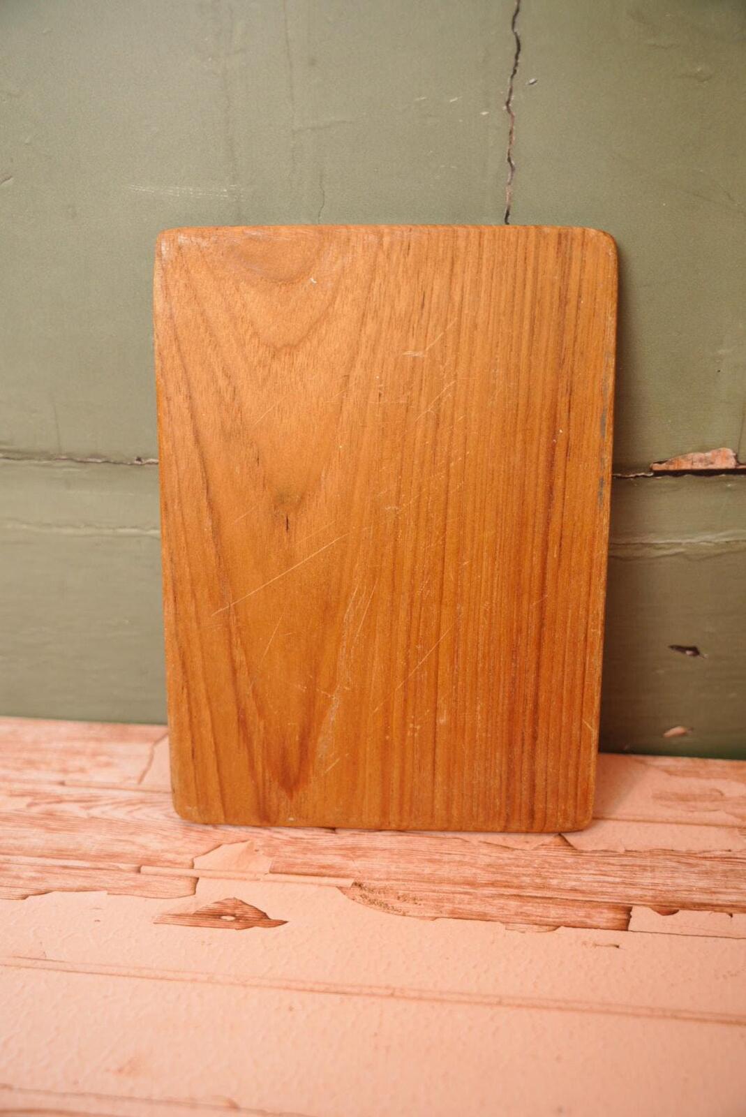 A vintage wooden chopping board for use in the kitchen.