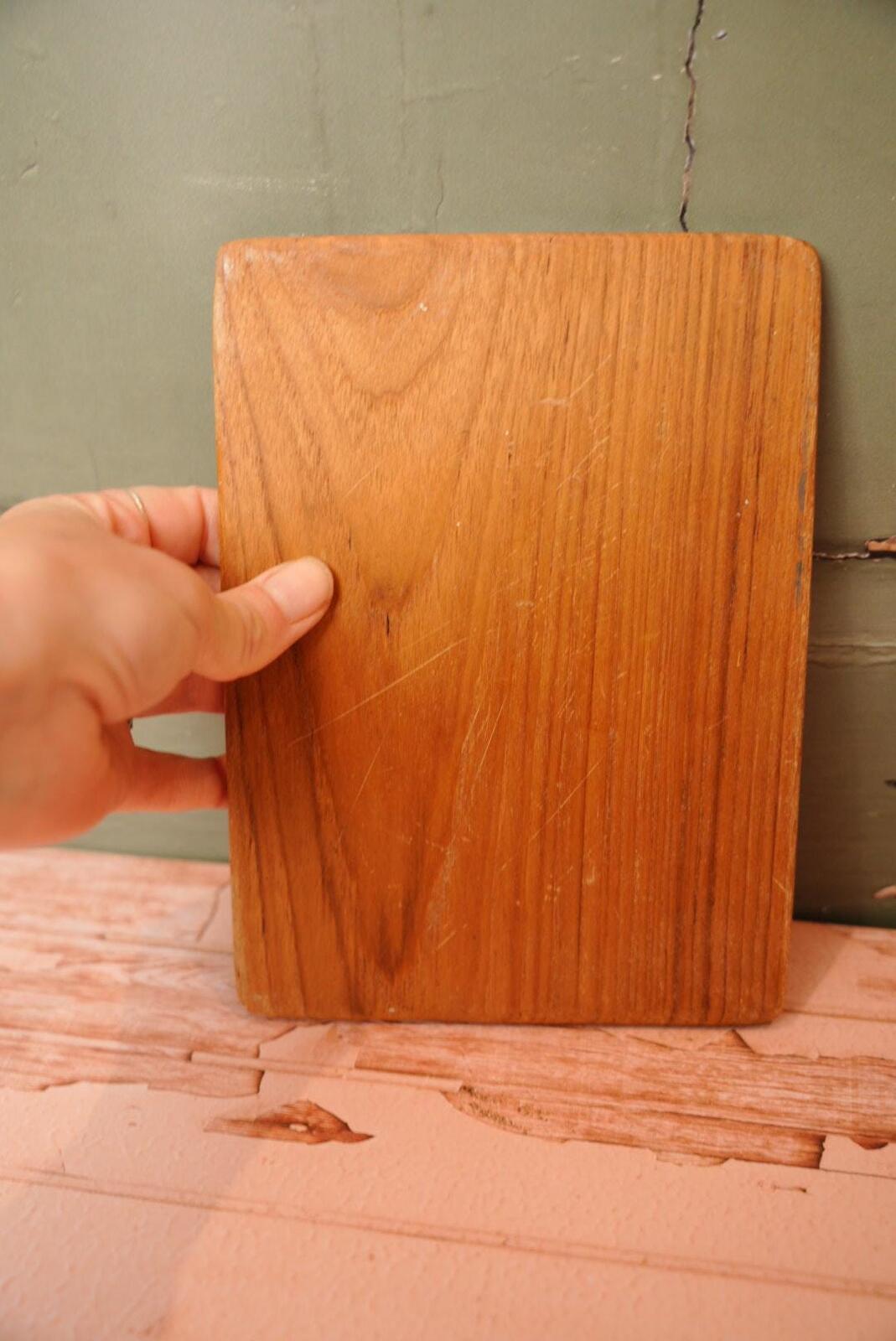 A vintage wooden chopping board for use in the kitchen.