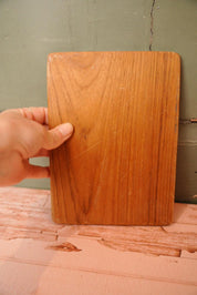 A vintage wooden chopping board for use in the kitchen.
