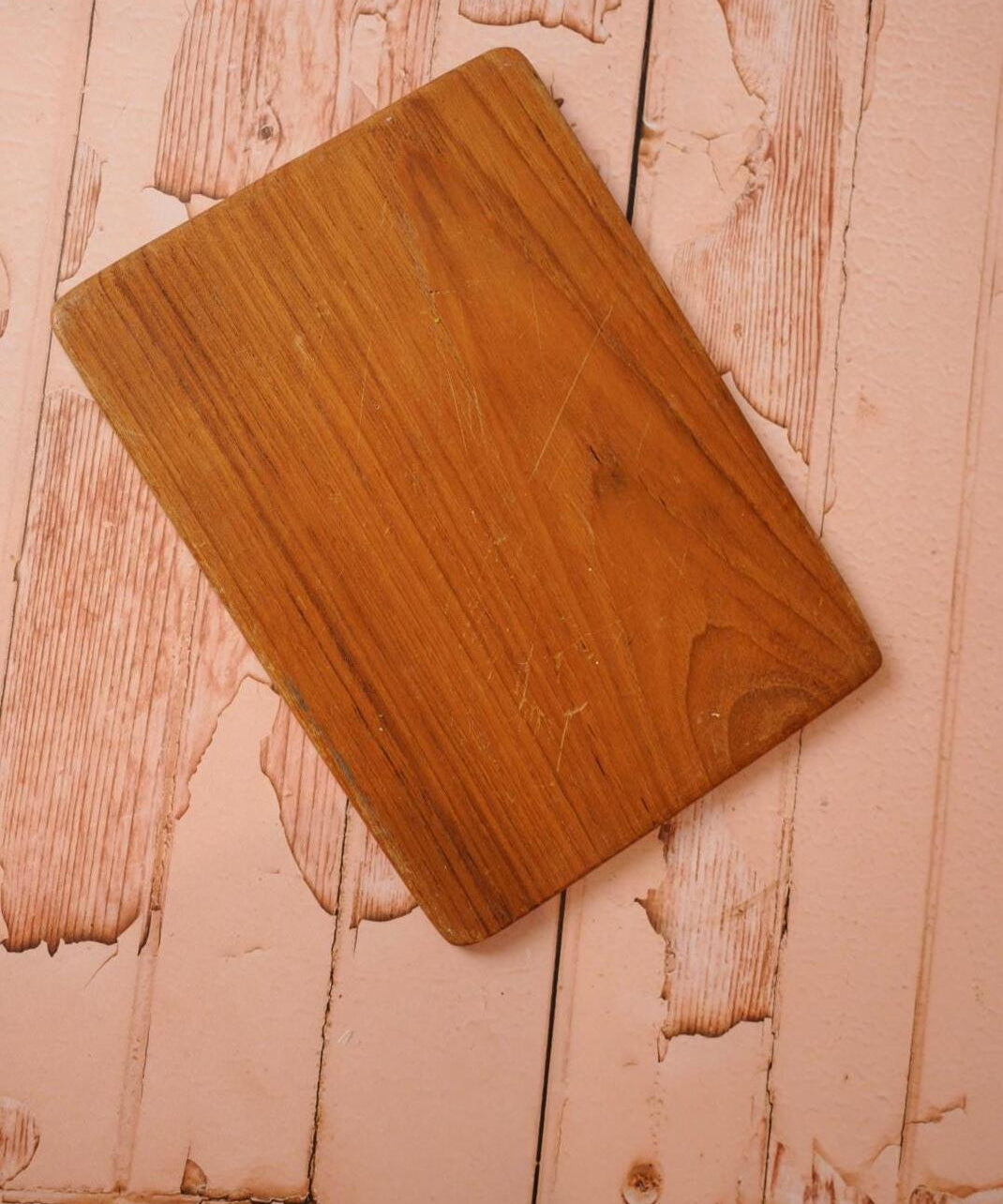 A vintage wooden chopping board for use in the kitchen.