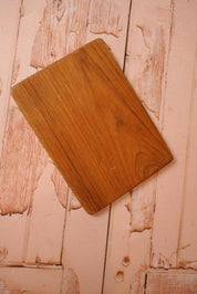 A vintage wooden chopping board for use in the kitchen.