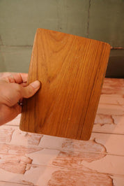 A vintage wooden chopping board for use in the kitchen.