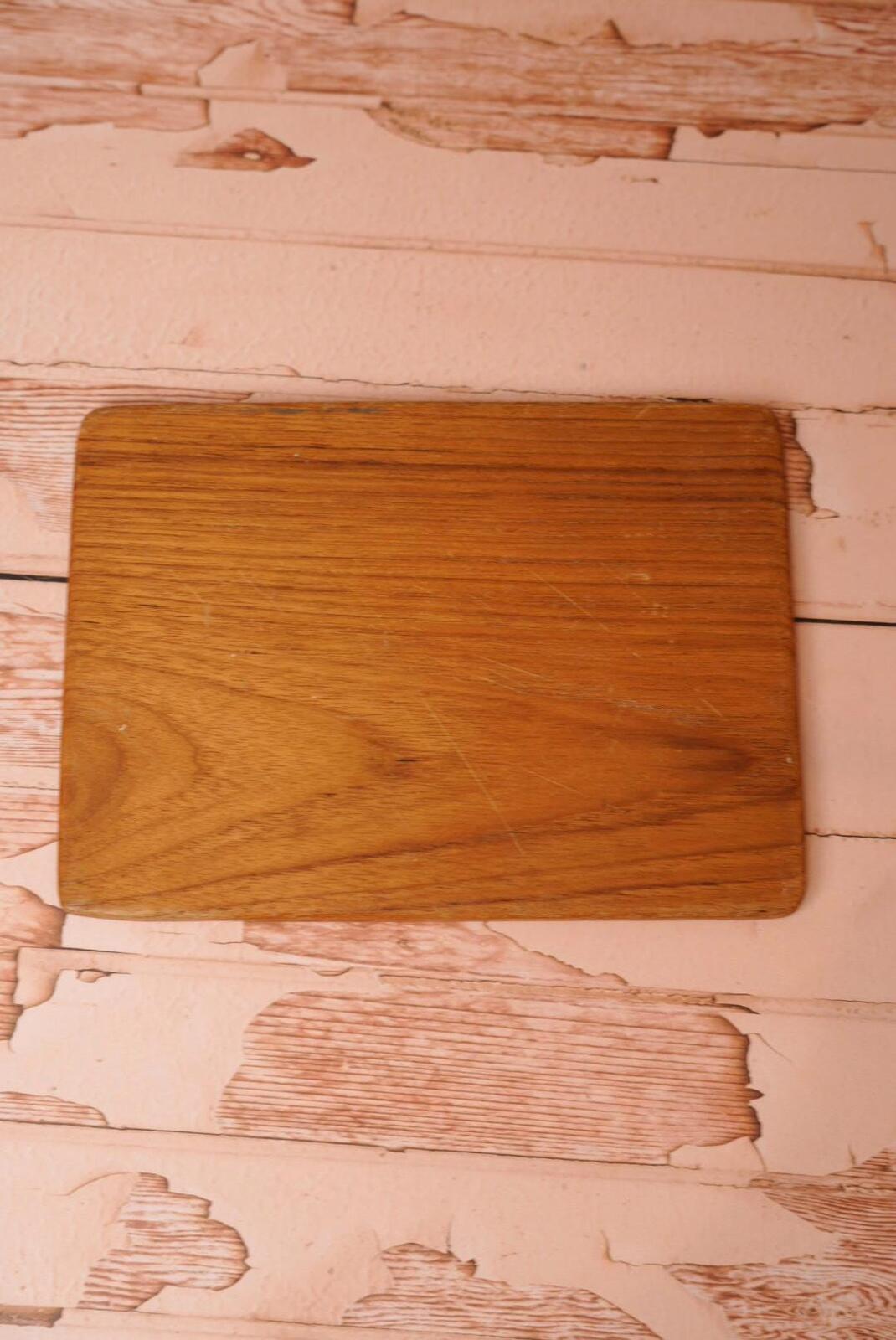 A vintage wooden chopping board for use in the kitchen.