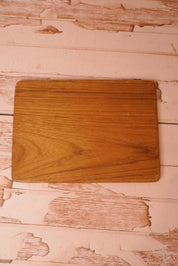 A vintage wooden chopping board for use in the kitchen.